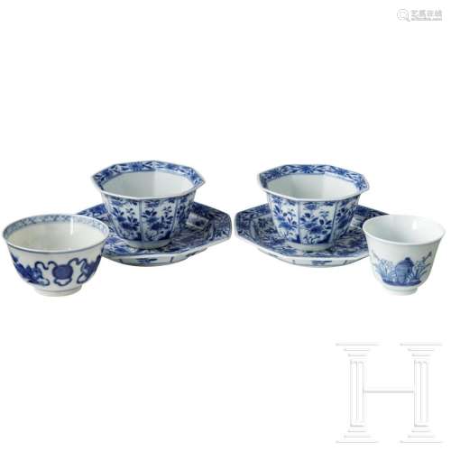 Two sets of blue and white cups and saucers, a small