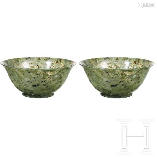 A mottled pair of spinach-green Chinese jade bowls,