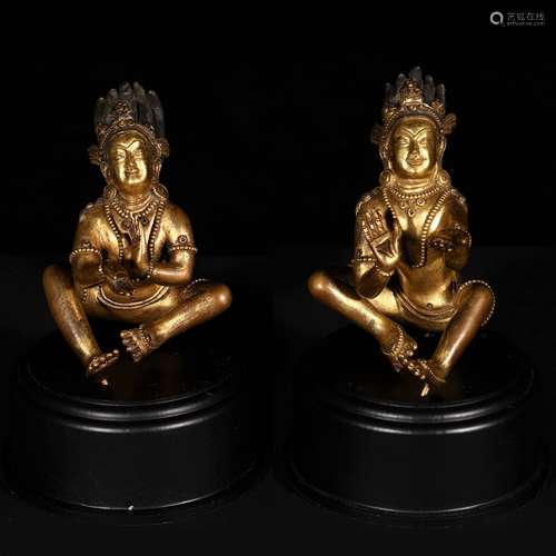 PAIR OF SINO-TIBETAN GILT BRONZE FIGURES ON STAND