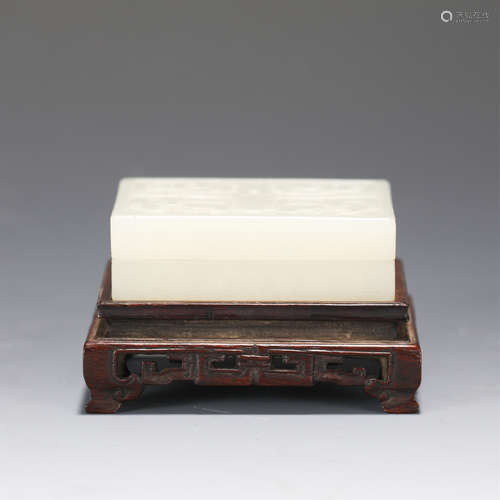 A CARVED WHITE JADE BOX WITH WOODEN STAND