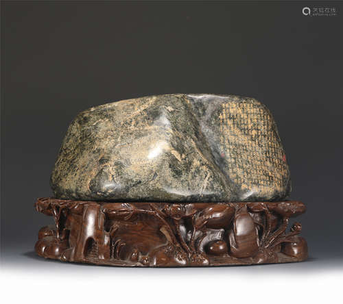 AN INSCRIBED JADEITE BOULDER WITH STAND