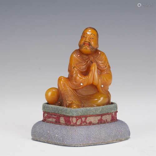 A CARVED SOAPSTONE SEATED ARHAT