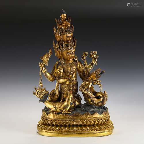 A SUPERBLY CASTED GILT BRONZE MULTI-HEAD PROTECTOR