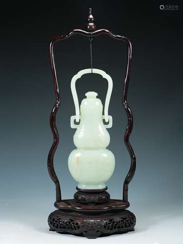 A CARVED WHITE JADE VASE WITH STAND