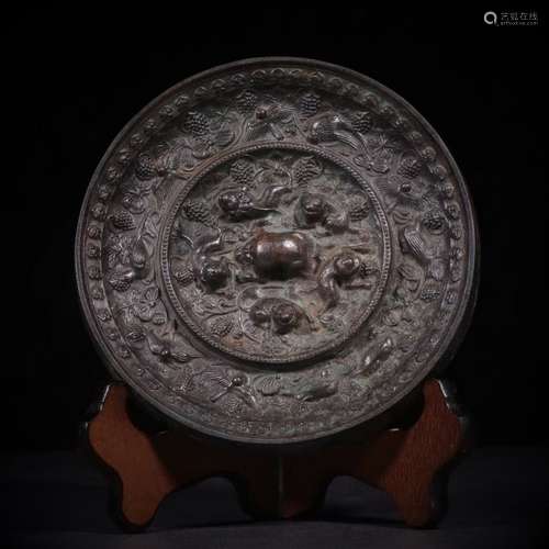 A BRONZE CIRCULAR MIRROR