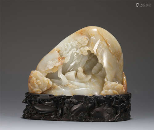 A CARVED WHITE AND CREAMY JADE BOULDER