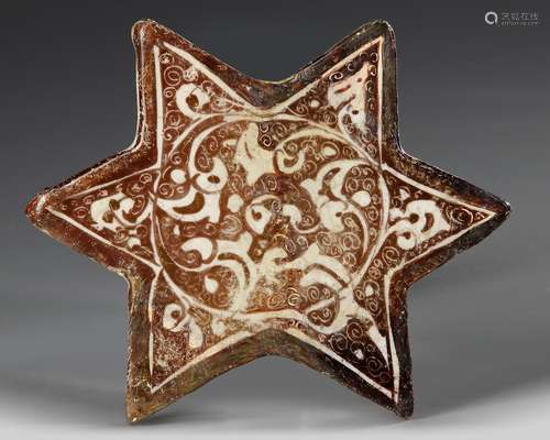 A SMALL STAR-SHAPED KASHAN TILE, PERSIA, 13TH-14TH