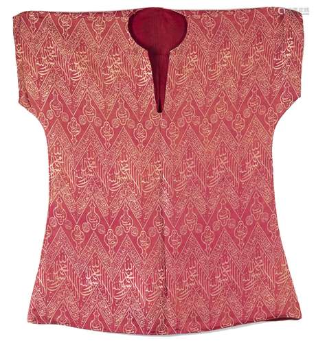 A SILK LAMPAS COVERING PANEL FORMED AS A KAFTAN,