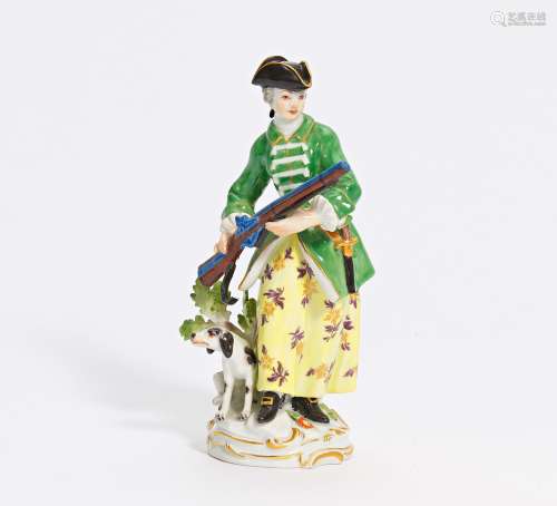 PORCELAIN FIGURINE OF A HUNTRESS WITH SHOTGUN AND DOG. Meiss...
