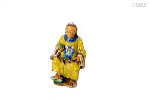 Polychrome ceramic sculpture depicting a sitting monkey, Chi...