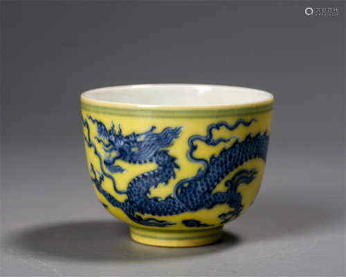 A CHINESE IMPERIAL YELLOW-GROUND BLUE AND WHITE DRAGON BOWL,...