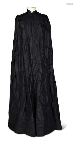 DAME EDITH INTEREST, A BLACK SILK LINED EVENING CAPE, EARLY ...