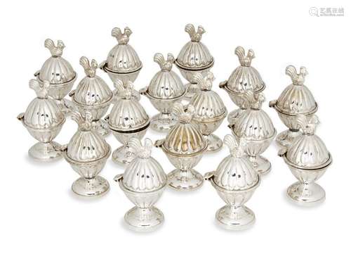 A set of sixteen novelty egg cups, each silver plated egg cu...