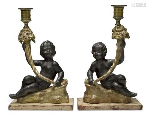 A pair of Regency gilt and black painted plaster candlestick...