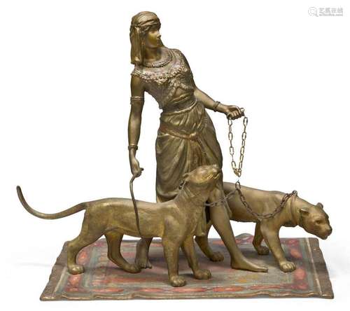 An Austrian cold-painted bronze model of a woman walking two...