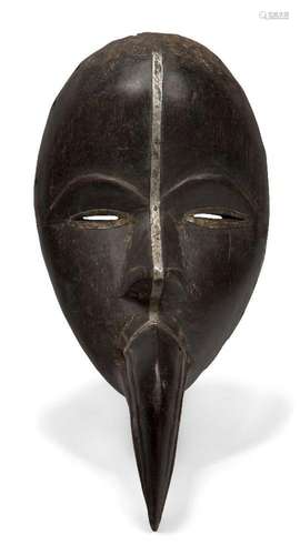 A Dan mask, Ivory Coast, 20th century, the oval face with ca...