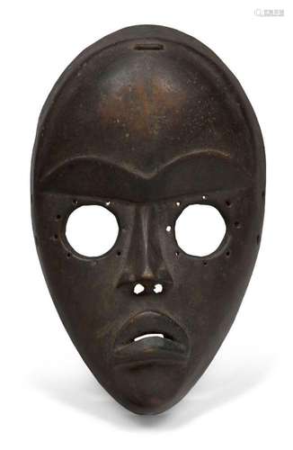 A Dan mask, Ivory Coast, 20th century, of oval form with cir...