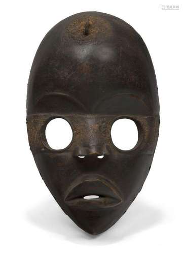 A Dan mask, Ivory Coast, 20th century, of oval form with cir...