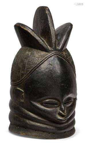 A Mende helmet mask, Sierra Leone, 20th century, with carved...