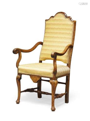 A Queen Anne walnut open armchair, c.1710, the top with a sh...