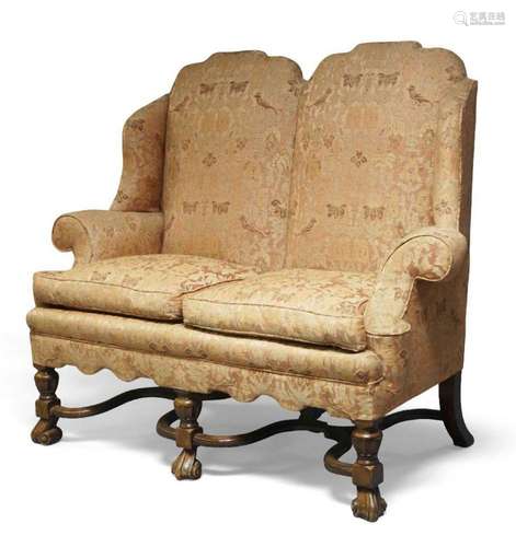 A William & Mary style two seater wing back sofa, uphols...