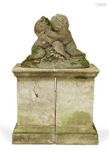 A carved stone model of two embracing putti, early 20th cent...