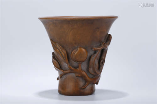 A Boxwood Cup with Longevous Peaches Design.