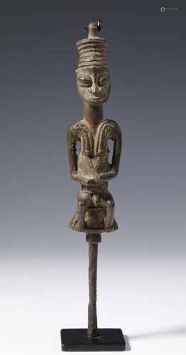 Nigeria, Yoruba, Ogboni, brass male Edan figure holding an a...