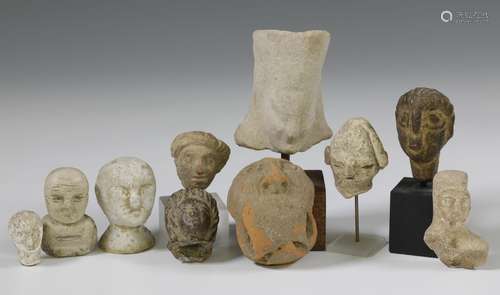 A collection of six terracotta and four stone Middle Eastern...