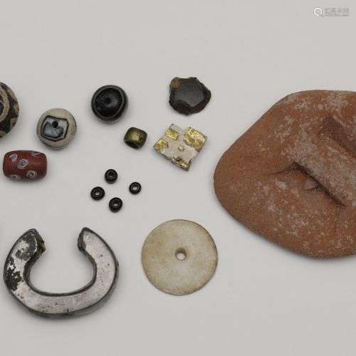 A collection of various antique beads, a terracotta slab and...