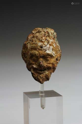 A Greek terracotta fine head of a Satyr, ca. 4th century BC.