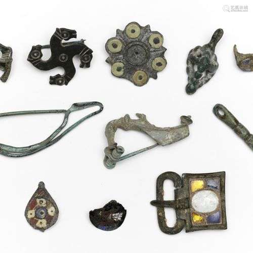 A collection of ten bronze fibula and a ring, Roman Period a...