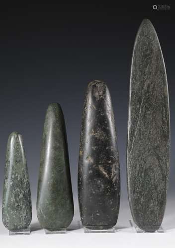 Papua, three green stone blades and a sacred green stone.