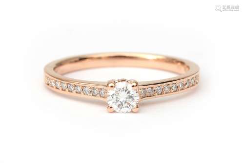 An 18 karat rose gold diamond solitaire ring, Featuring a br...