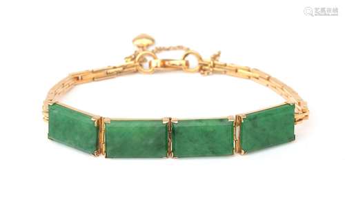 An 18 karat gold jadeite bracelet. Composed of elongated sli...