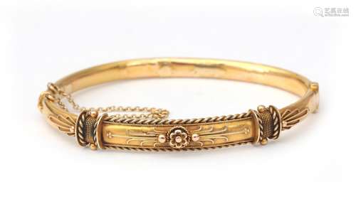 A 15 karat gold neo Etruscan bangle. The front is decorated ...