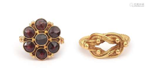 A pair of two gold rings. One plain gold ring of twisted des...