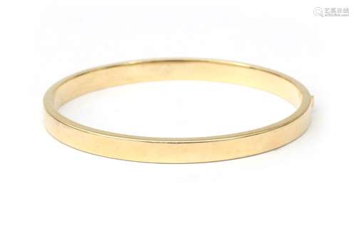 Un bangle en or 14 carats. De conception moderne avec des bo...