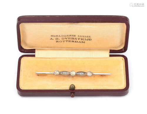 A 14 karat gold diamond bar brooch. Featuring three larger r...