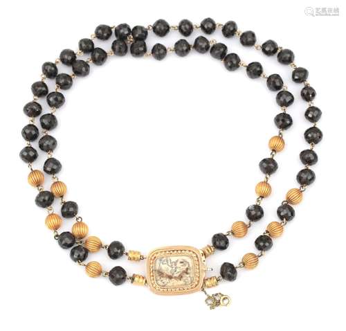 A garnet necklace with a 14 karat gold clasp. Double strand ...