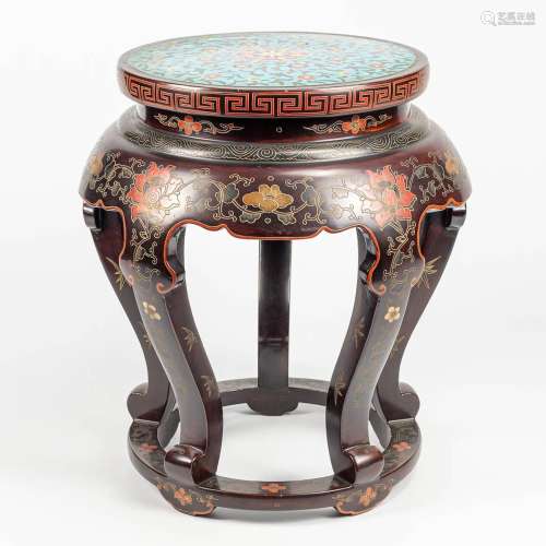 A side table decorated with flowers and finished with cloiso...