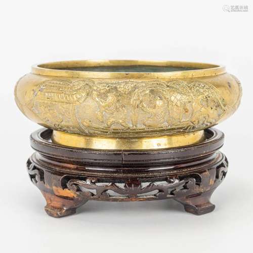 A bronze brûle parfum bowl, on a wood base. Marked Xuande.