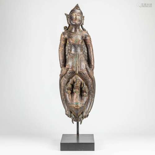 A large oriental sculptured statue of a mythological figurin...