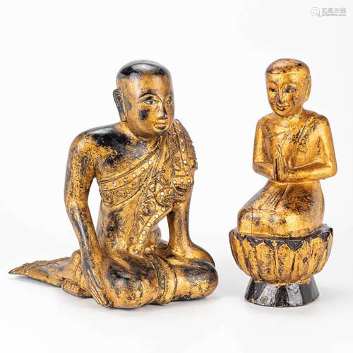 A pair of Buddha's made of gilt sculptured wood.