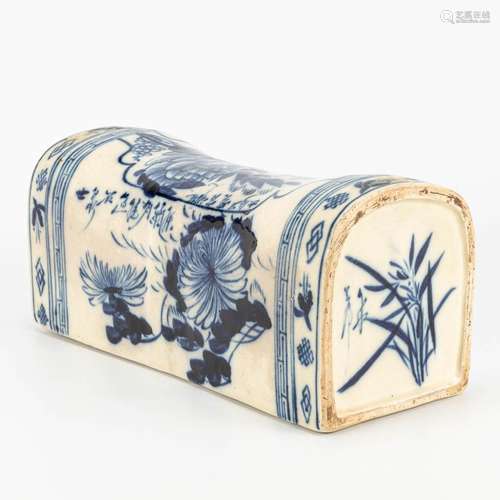 A porcelain pillow made in China and decorated with blue-whi...