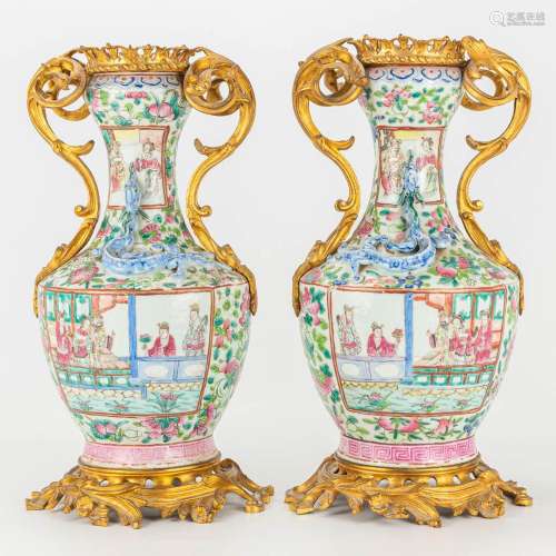 A pair of bronze mounted porcelain vases made of Chinese por...
