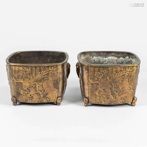 A pair of Oriental cache pots made of bronze and decorated w...