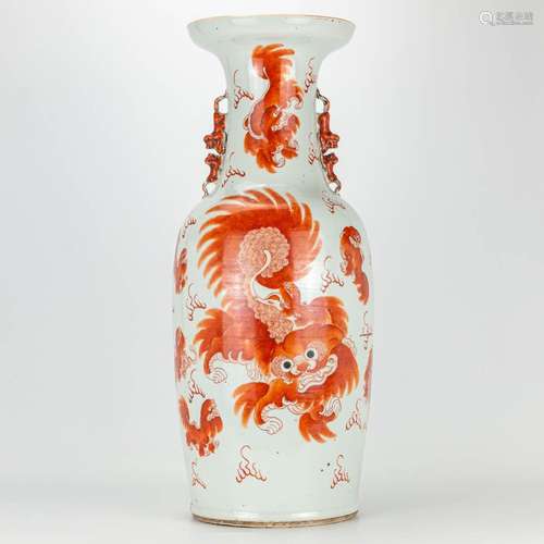 A vase made of Chinese porcelain with decor of a red foo dog...