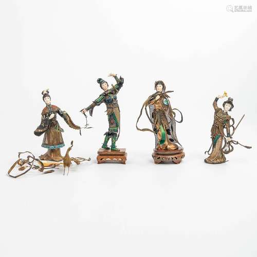 A collection of 4 figurines with weapons and music instrumen...