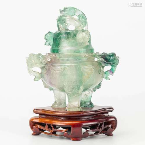 A Chinese Koro with lid, made of Jade on a wood base.